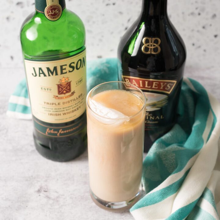 Jameson Whiskey and Bailey’s Irish Cream poured over a glass of ice.