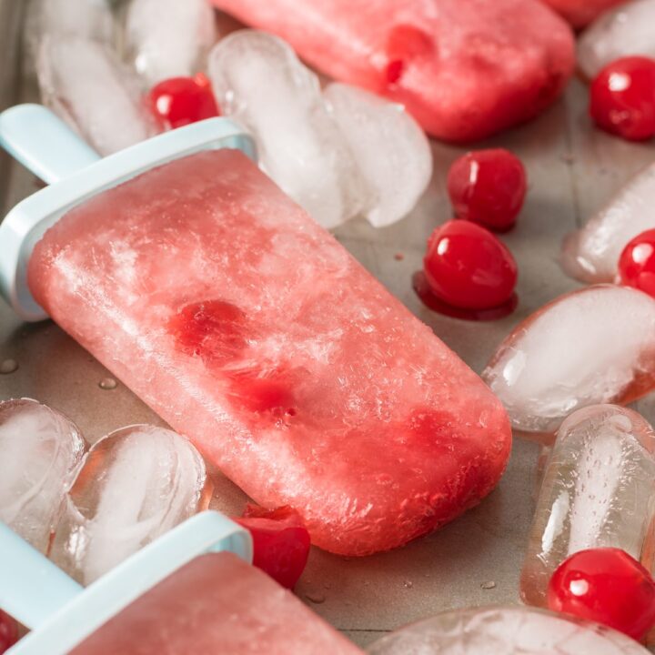 popsicles made with ginger soda, grenadine and cherries