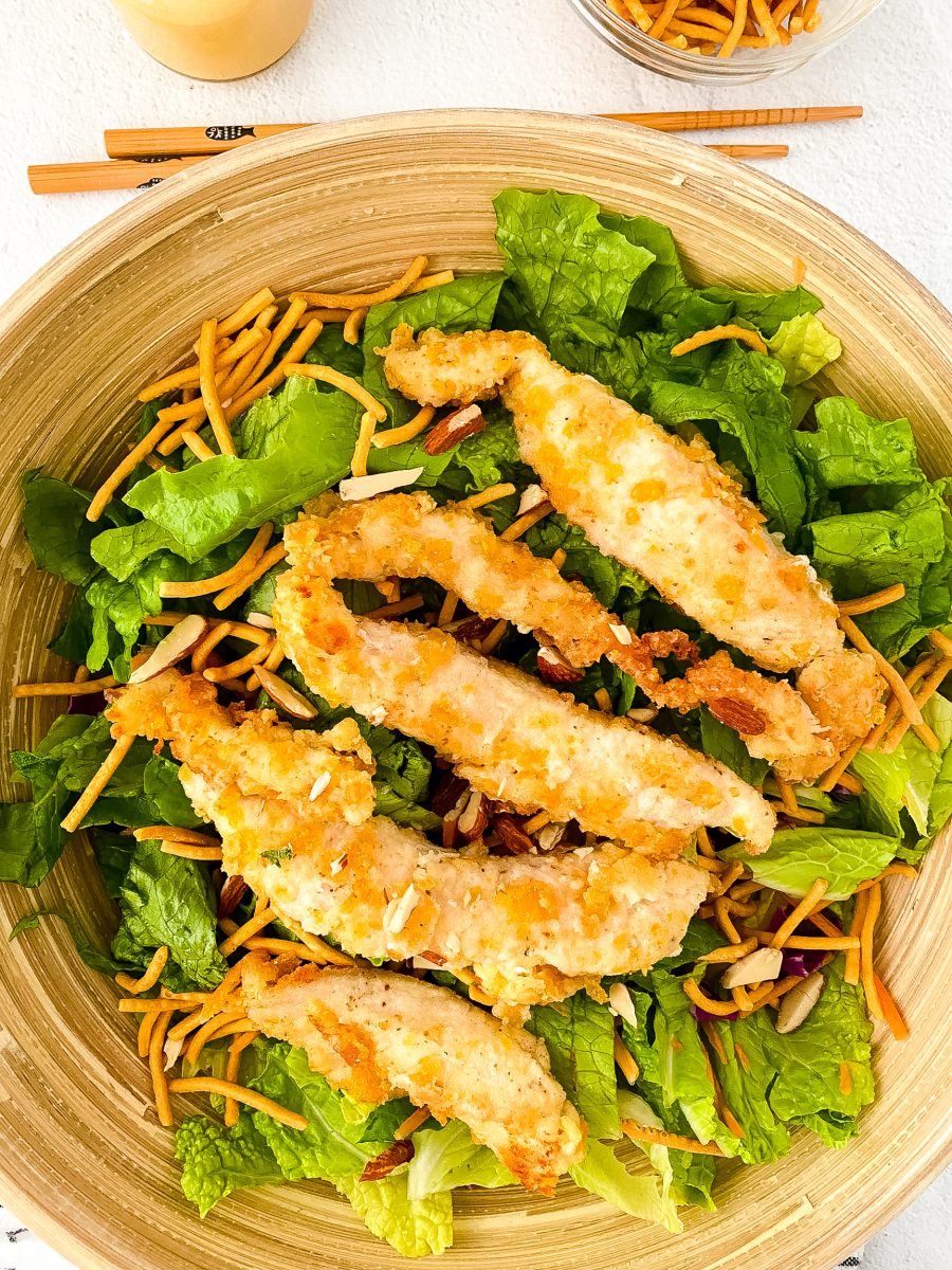 Large Bowl of chicken strips in oriental salad that is a copycat of Applebees recipe