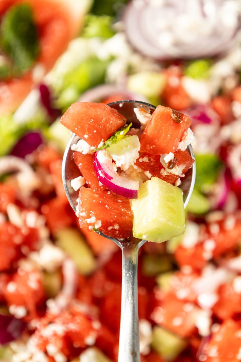Watermelon salad made with feta, cucumbers, onions and mint leaves