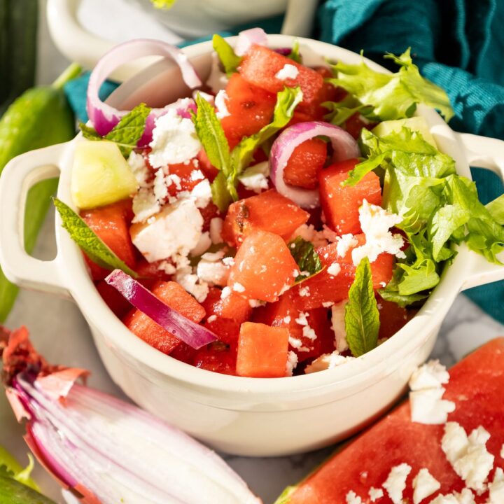 Watermelon salad made with feta, cucumbers, onions and mint leaves