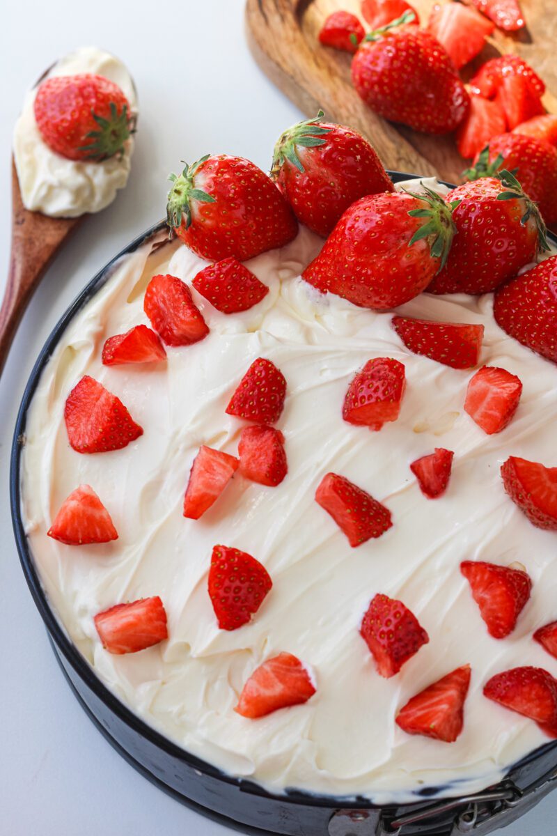 Poke cake made with vanilla cake mix and fresh strawberries