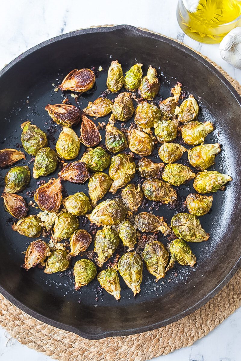 Fresh Brussels roasted in a cast iron skillet in the oven
