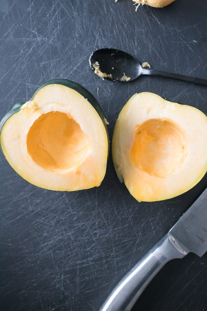 Prepare your acorn squash by slicing it in half from top to bottom