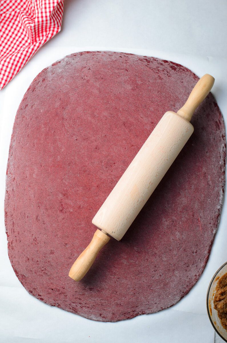Using a rolling pin, roll the dough out into the shape of a rectangle